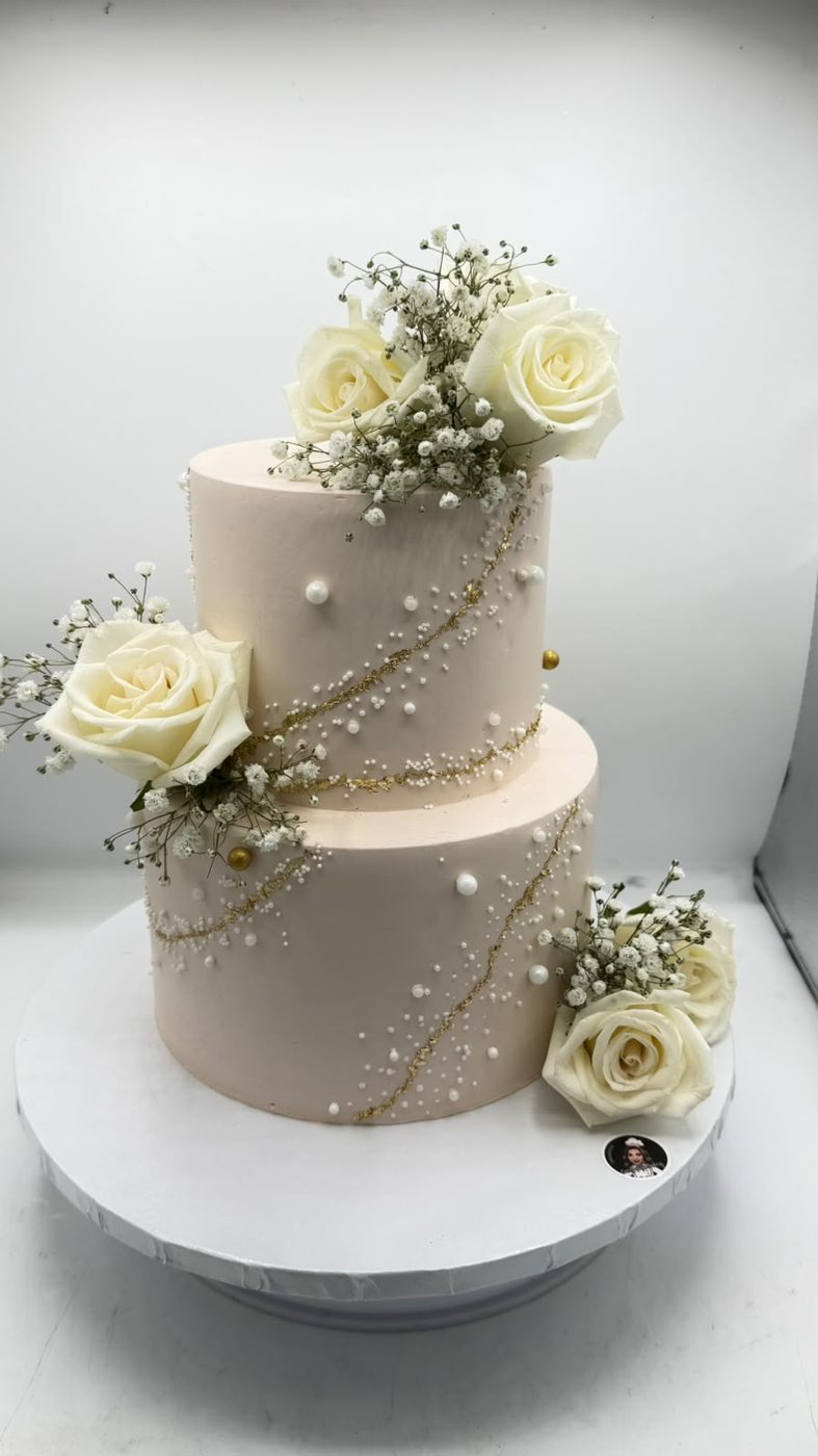 Elegant white tiered cake with roses